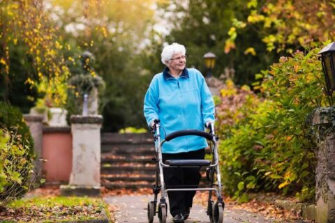 Old lady walking in garden