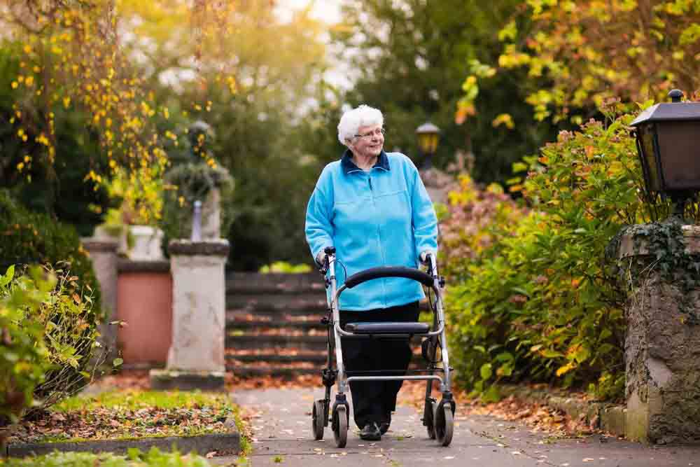 Old lady walking in garden